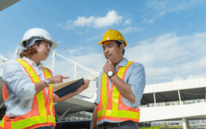 Construction manager and employee discussing how to prevent unethical construction practices