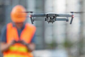 Worker using a drone at the construction site