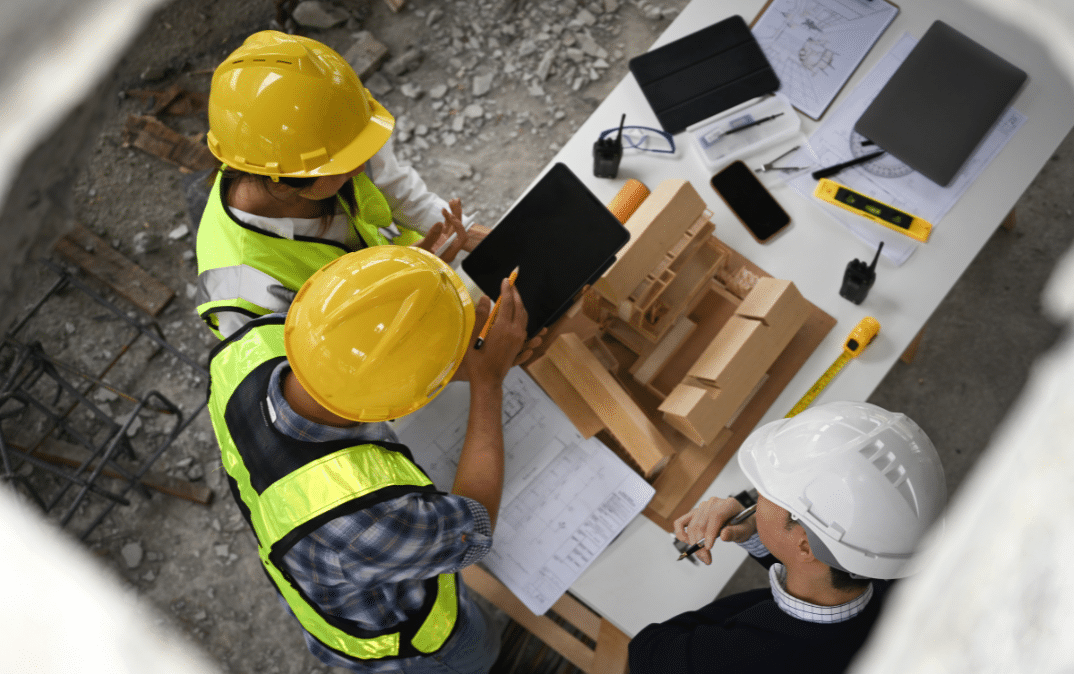 Construction project managers reviewing information at the job site