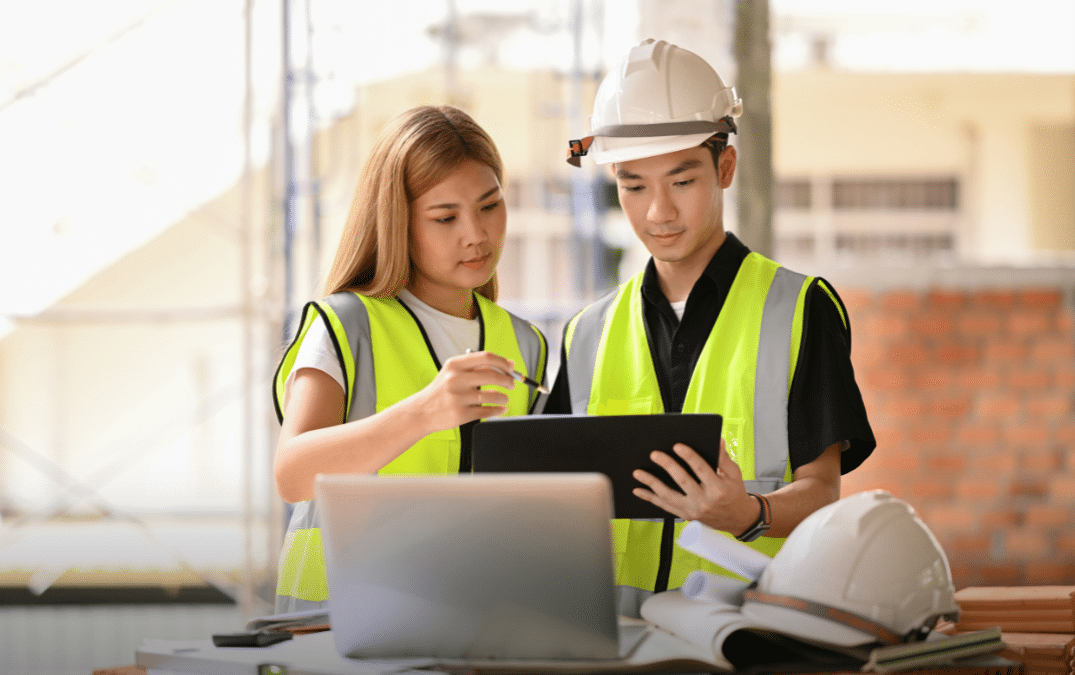 Construction manager shaking hands with a construction worker at the job site