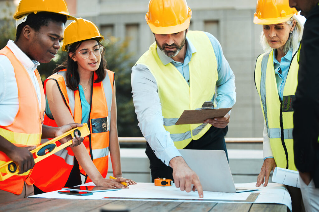 Construction manager leading a group of professionals before performing work at the job site