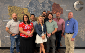 Conroe ISD’s construction professionals gathered in front of a map representing the area they service.